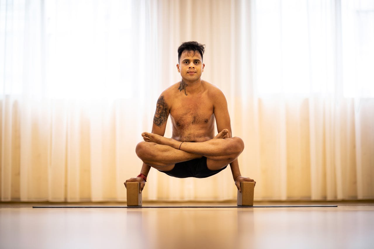 project-02-b Adult man performing advanced yoga pose with focus on balance and strength.