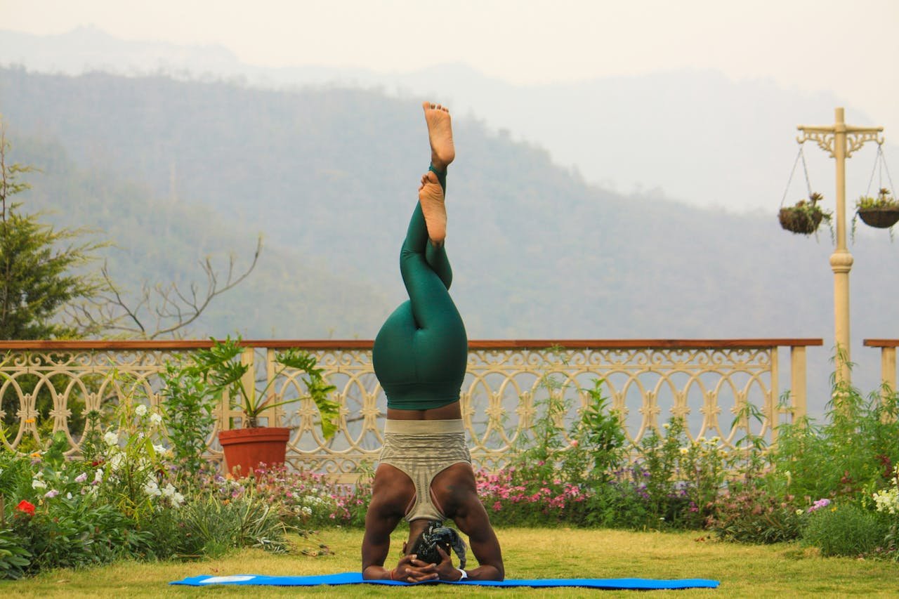project-02-a Person practicing yoga headstand outdoors in scenic Rishikesh, India.
