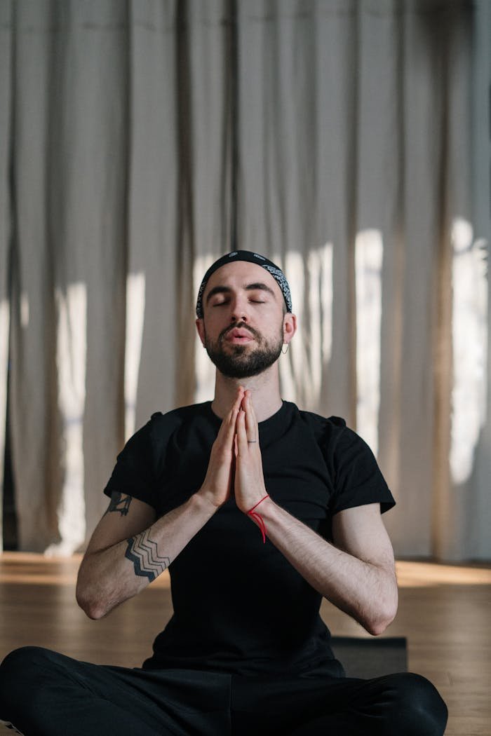 project-03-c A man meditating in a yoga studio, promoting wellness and relaxation.